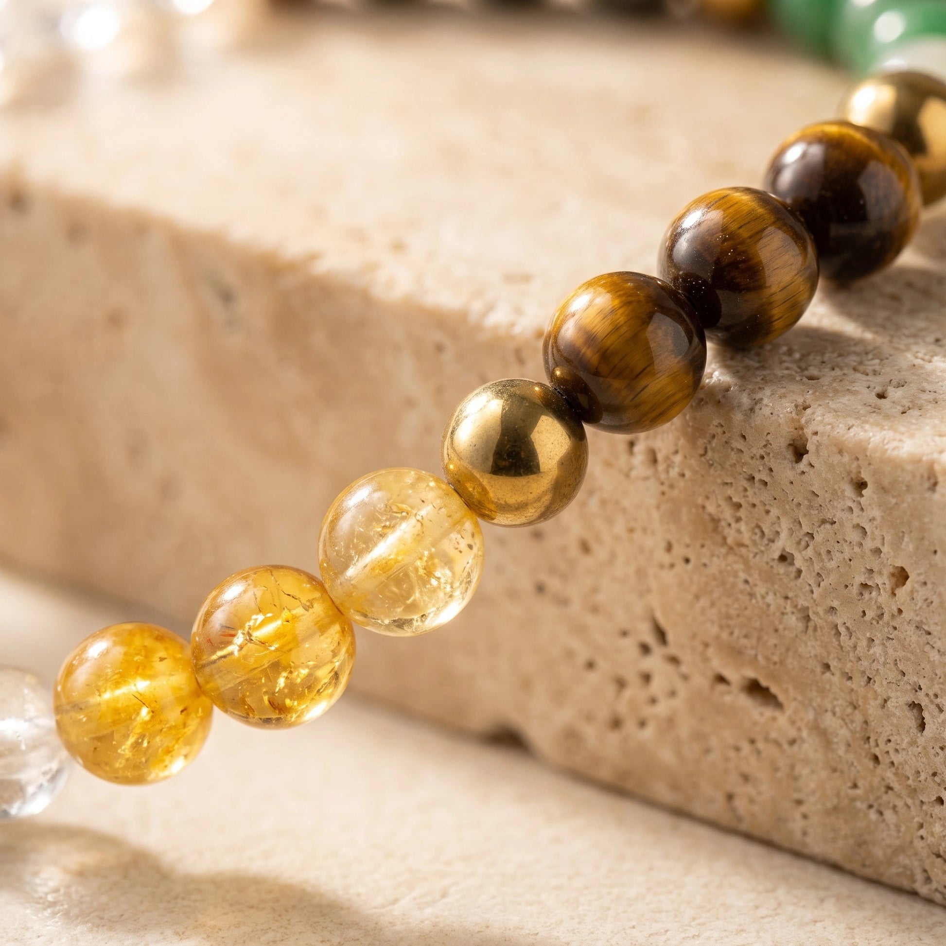 Close-up of the Dhan Yog Bracelet showcasing natural Citrine, Pyrite, Tiger Eye, Green Aventurine, Green Jade, Clear Quartz and Golden Hematite gemstones.